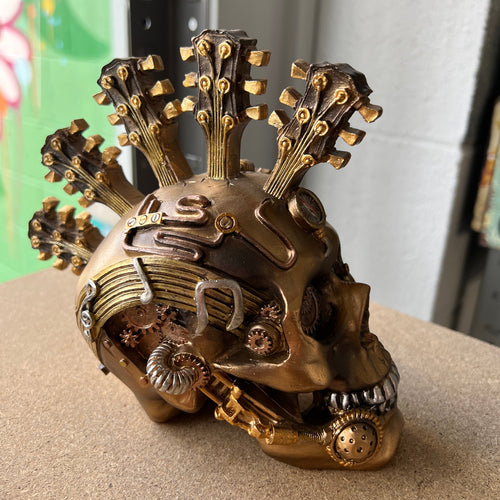 Introducing the Steampunk Guitar Skull - a fusion of musical rebellion and industrial chic. Perfect for eclectic decor, this quirky skull sculpture brings a symphony of style to your space